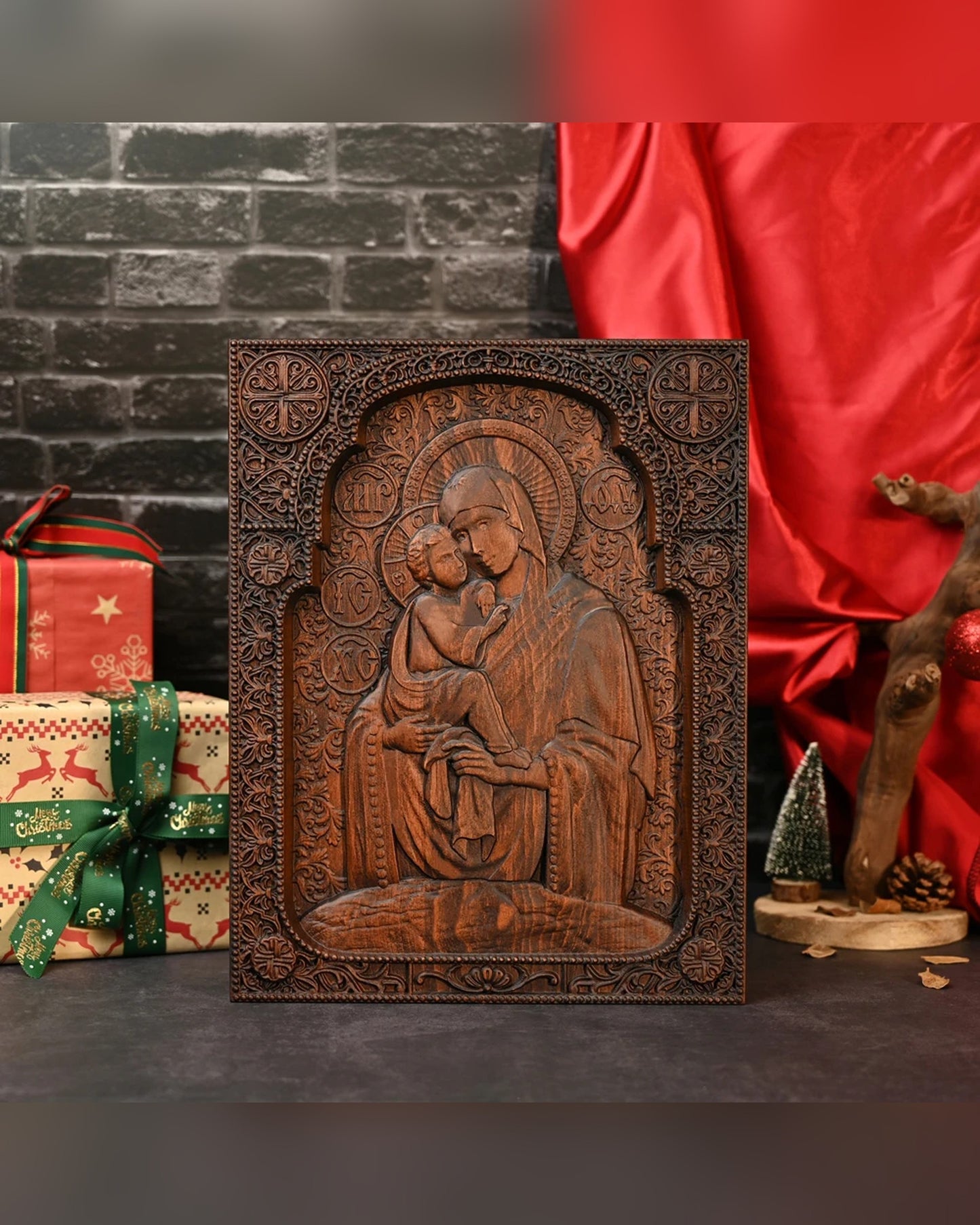 The carved Pochaev icon standing against a brick wall
