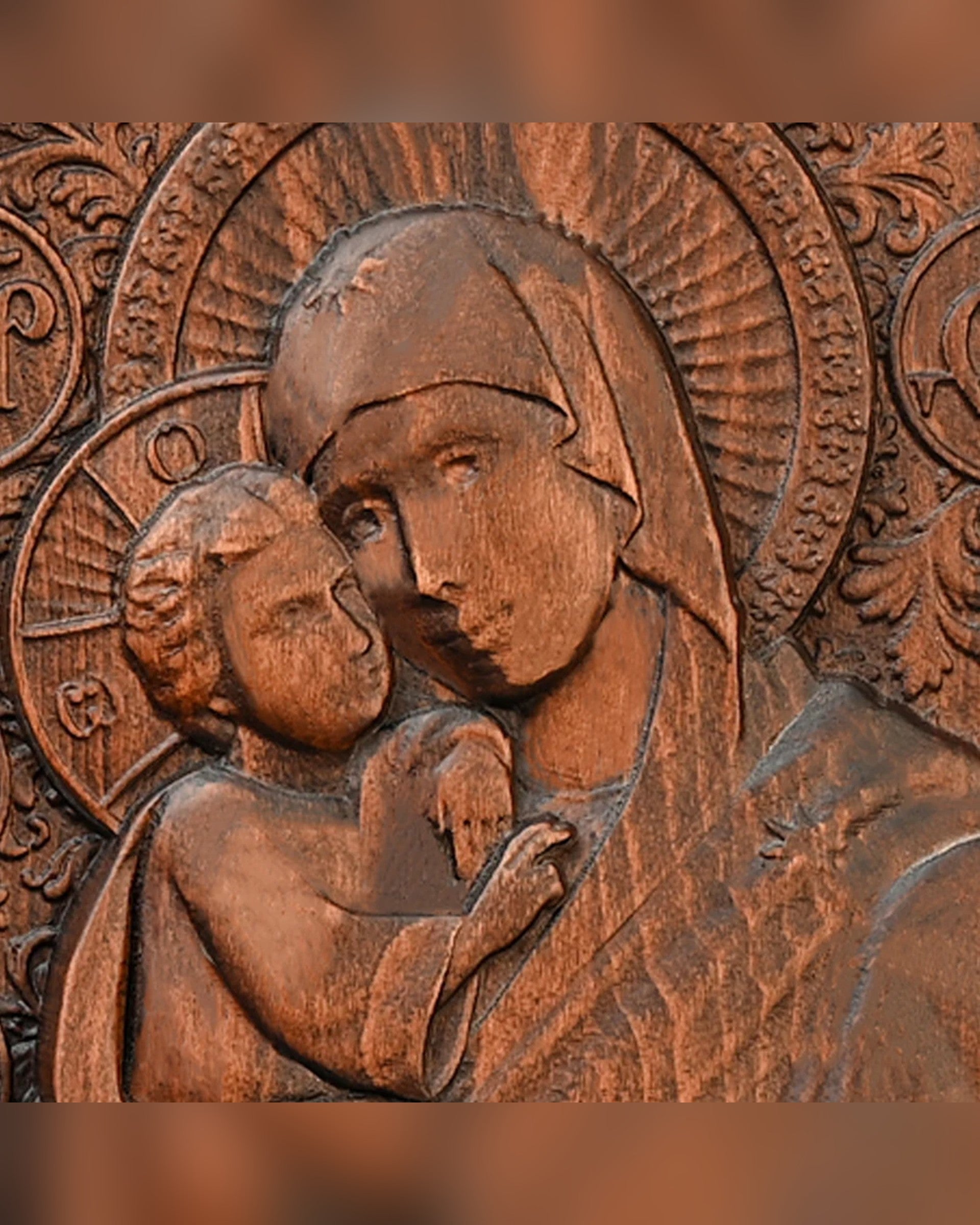 Close detail of the carved faces and halo